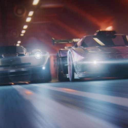 Captura de pantalla de Screamer mostrando dos vehículos deportivos futuristas acelerando a gran velocidad por el interior de un túnel iluminado con luces cenitales amarillas y destellos frontales, con el logotipo del juego en la esquina inferior derecha.