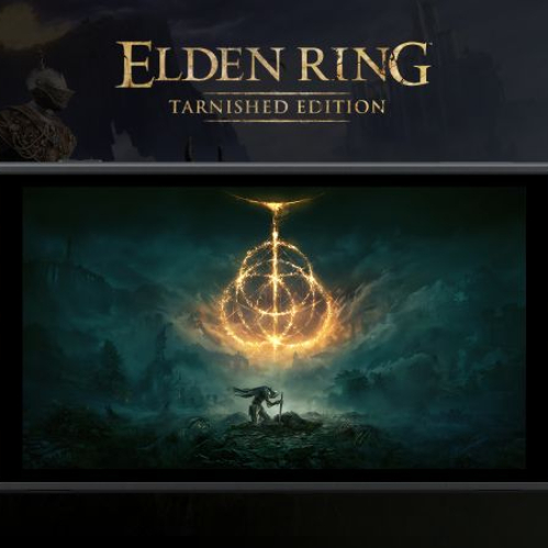 Fotografía del prototipo de la consola portátil Nintendo Switch 2 de color gris oscuro, mostrando en su pantalla la imagen oficial del logotipo de ELDEN RING Tarnished Edition. La pantalla exhibe el Anillo de Elden brillando en tonos dorados sobre un fondo oscuro y nebuloso con la silueta de un guerrero rodillado al frente. En la esquina superior izquierda se aprecia el logotipo blanco y rojo de Nintendo Switch 2.