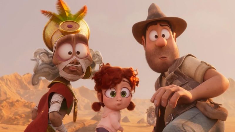 Momia, la pequeña Olimpia y Tadeo Jones observando sorprendidos hacia el frente en un entorno desértico.