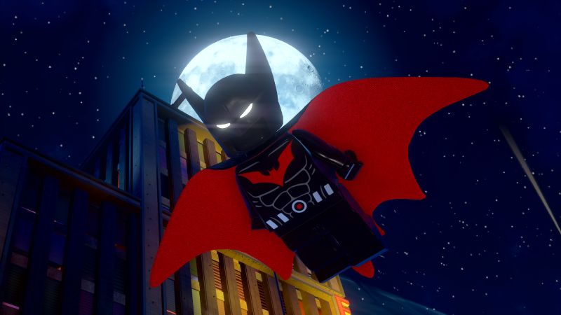 Figura estilo LEGO de un personaje en traje oscuro con detalles rojos, volando frente a una luna llena en un entorno urbano nocturno.